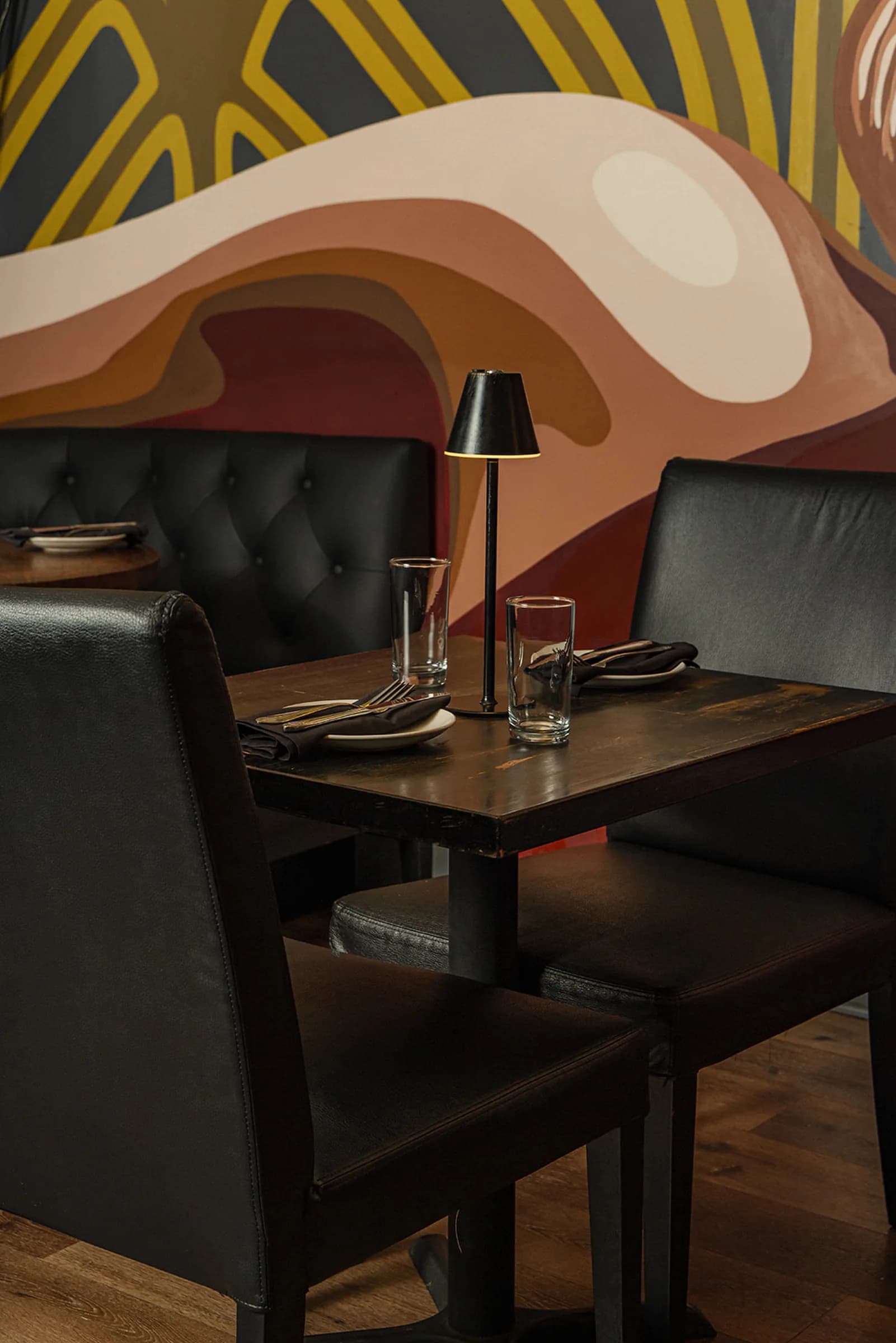 Booth table beneath the Art Deco mural
