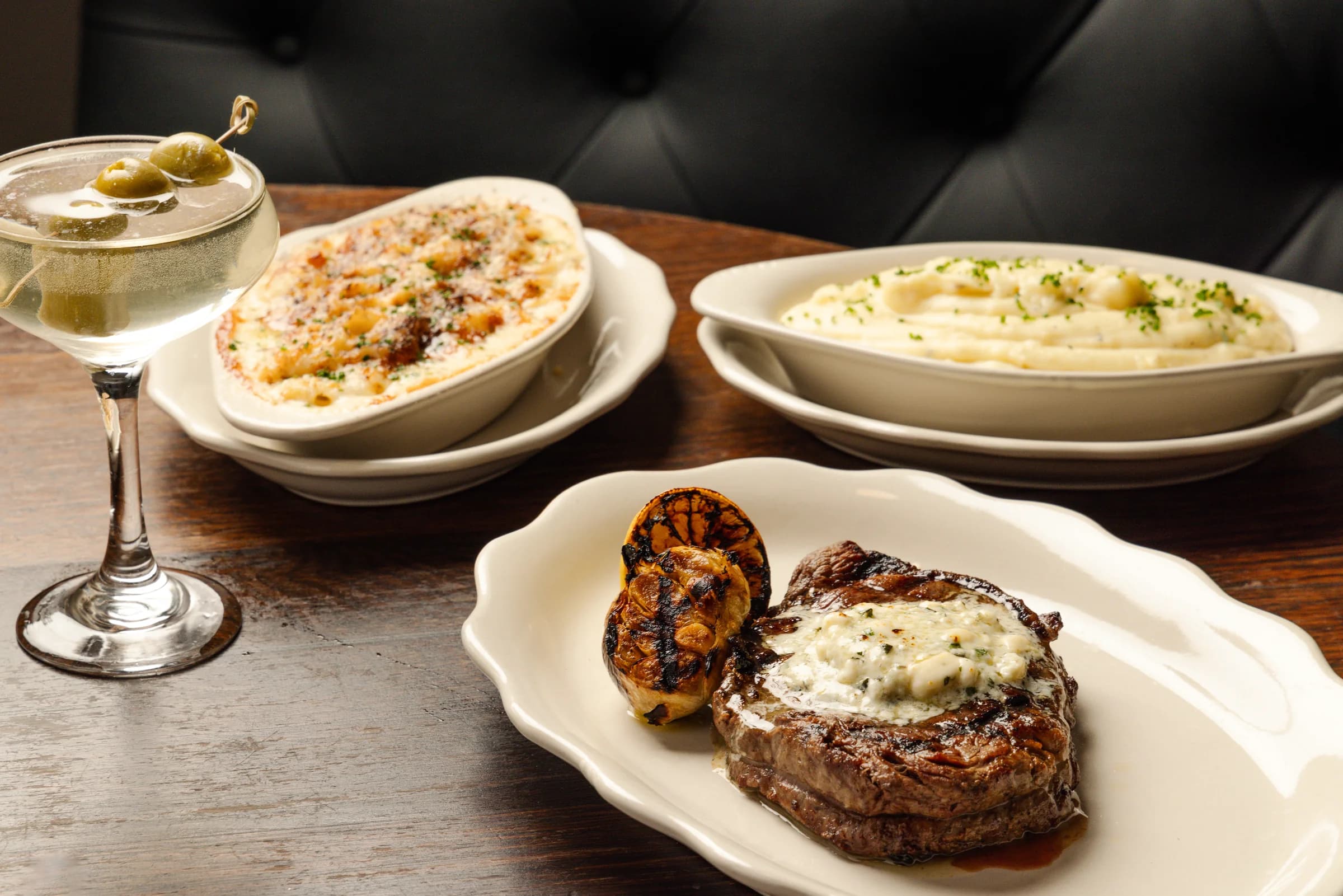 Filet with garlic butter, sides, and a martini
